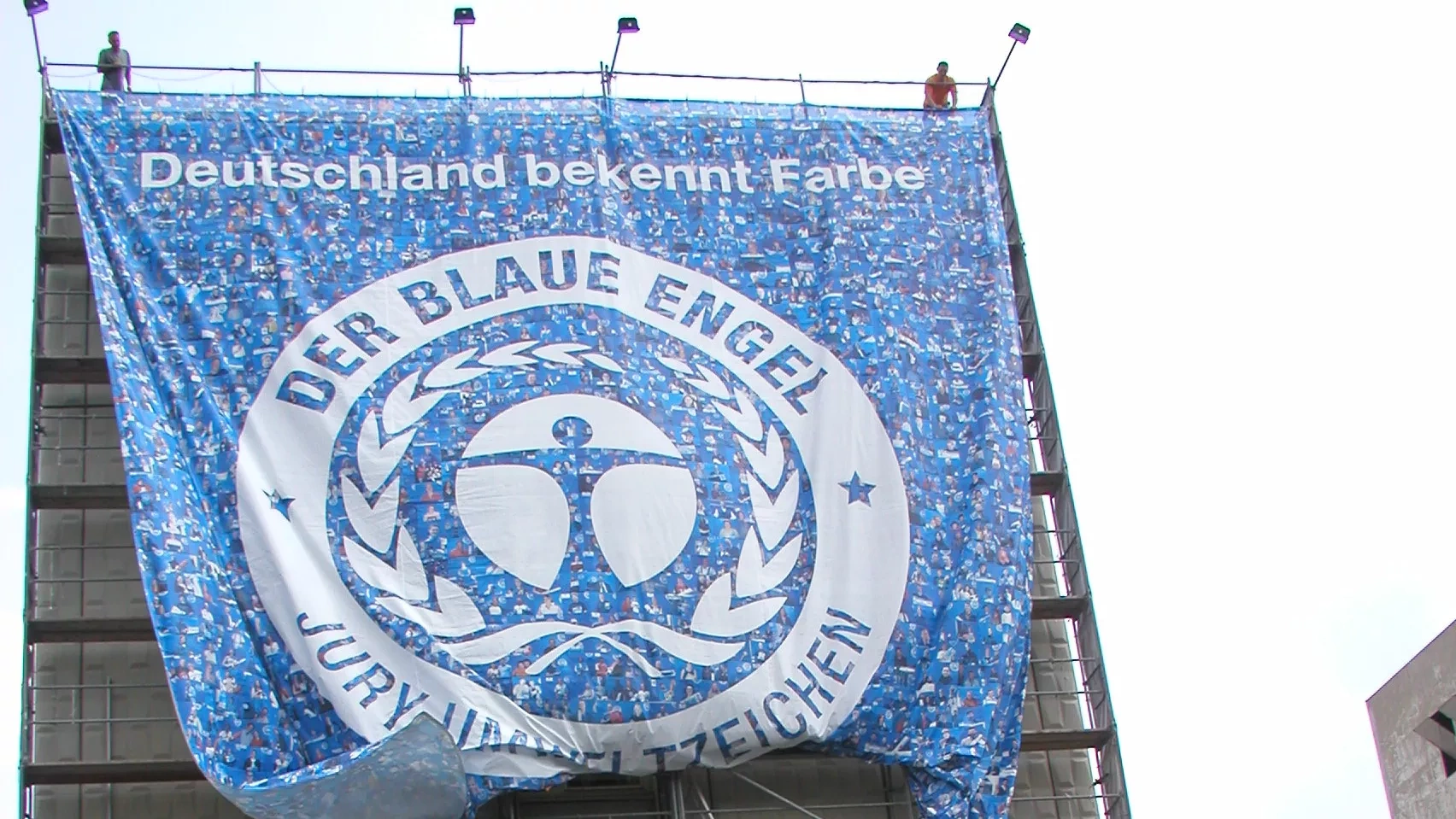 Huge canvas with the Blue Angel logo on a house wall