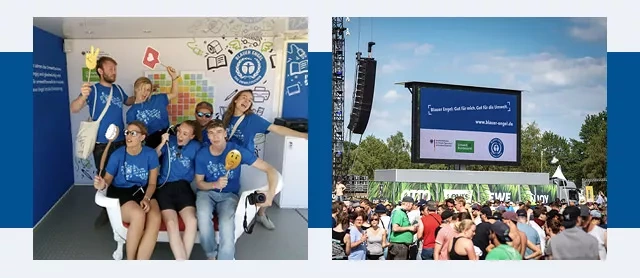 Group of young people in Blue Angel T-shirts and a large screen with advertising for the Blue Angel above the festival visitors