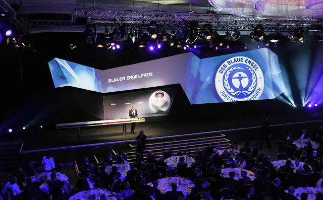 Audience in front of a stage with speaker of the German Sustainability Award