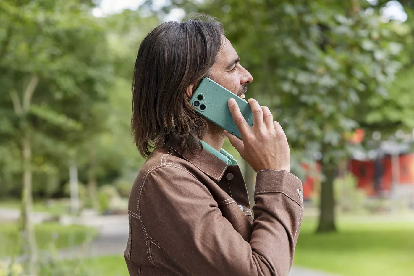 Smiling man speaks into a Fairphone